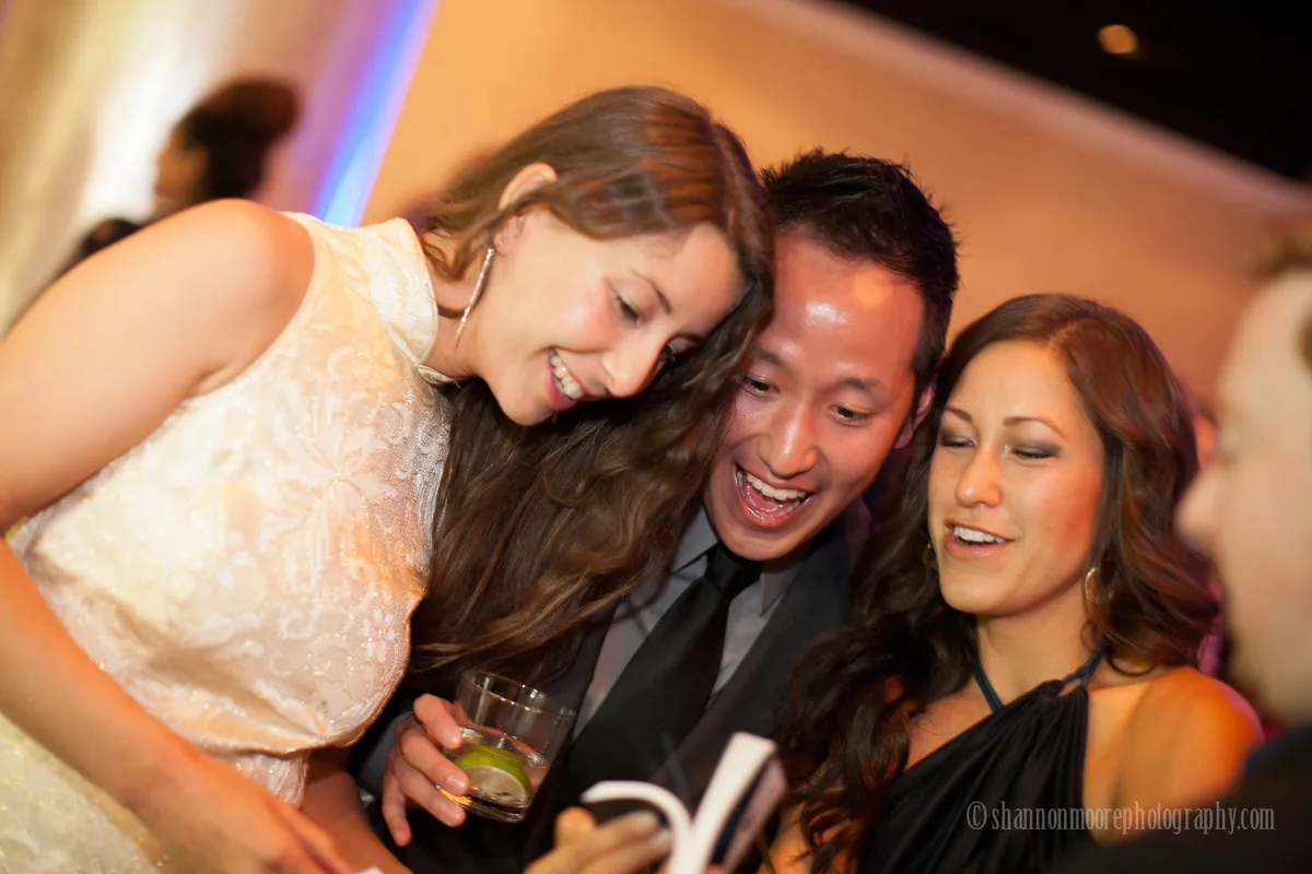 Event guests laughing and enjoying a flipbook activation